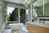Bath Room, Ceramic Tile Wall, Undermount Sink, Enclosed Shower, Engineered Quartz Counter, Freestanding Tub, Ceiling Lighting, One Piece Toilet, and Porcelain Tile Floor View of primary bath  Photo 14 of 14 in Bainbridge House by FINNE Architects