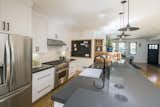 Kitchen with island, Carrara marble slab backsplash, wolf range