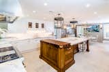 The kitchen and butler's pantry were designed by Christopher Peacock, world-renowned cabinetry and hardware designer whose work is the hallmark of today's luxury kitchen. The counters and backsplash  are made of Calacatta marble. The expansive center island features a walnut top prep area. Wolf/SubZero appliances include a 48" dual fuel range, 60" metal hood, 48" refrigerator drawers, wine refrigerator, and two Asko dishwashers. 