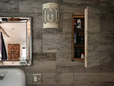 Bath Room, Wall Lighting, Stone Tile Wall, and Wall Mount Sink Master bathroom with speakeasy medicine cabinets  Photo 12 of 12 in Bruyn House at Red Mill's Farm by Colan Andrew McGeehan
