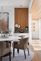 Dining Room, Accent Lighting, Ceiling Lighting, Medium Hardwood Floor, Pendant Lighting, Table, Recessed Lighting, Storage, and Chair  Photo 12 of 28 in Bayview House by Leader Design Studio