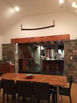 View from dining room to kitchen with reclaimed beams and table