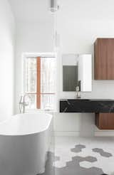 Bath Room, Stone Counter, One Piece Toilet, Porcelain Tile Floor, Drop In Sink, Pendant Lighting, Open Shower, and Freestanding Tub Views from the master bath  Photo 7 of 16 in The Glass House by AmyDutton Home