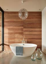 A Moooi chandelier hangs above the soaking tub