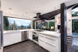 PIcture window in the kitchen overlooks Vancouver's skyline and Lions Gate Bridge