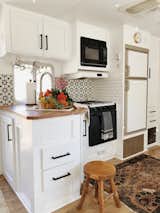 I used cement tile and subway tile to add a fun pop in the kitchen. I also refaced all the cabinets to a shaker style to really update the kitchen and modernize the RV. 