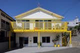 House of Many Arches by 24d-studio front facade is white with bright yellow balcony