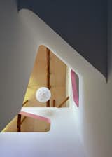 Staircase, Wood Tread, and Wood Railing 24d-studio residential arches and atrium space as seen from 1st floor with birch plywood and Flower Ball Large Pendant Light  Photo 17 of 22 in House Of Many Arches by Marina Topunova
