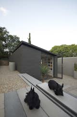 The home office is accessed from the entrance courtyard. The Scottish terriers Maya & Eva in the foreground.