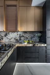 Kitchen, Granite Counter, Ceiling Lighting, Laminate Cabinet, Cooktops, Metal Cabinet, Drop In Sink, Stone Slab Backsplashe, Refrigerator, Recessed Lighting, Wall Oven, and Marble Floor kitchen  Photo 10 of 25 in Utopia Grand by Aum Architects