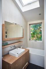 Bath Room, Wood Counter, Freestanding Tub, Accent Lighting, Ceiling Lighting, Vessel Sink, Porcelain Tile Wall, and Porcelain Tile Floor  Photo 10 of 14 in Architects House in Venice Beach by Jade Towery