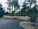 Natural Michigan Fieldstone hold back the hillside to accommodate parking for guest