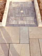 Natural blue stone meets Unilock series 3000 and brussels block  to create a clean entrance to the back door in Brighton MI.
