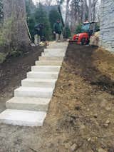 Guillotine cut limestone steps create the grade for the transition to this back yard in Ann Arbor MI