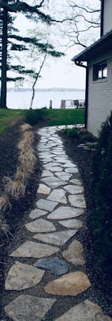 Natural Flagstone set in decomposed give a clean safe walkway down to the lake in this waterfront home in Bloomfield Hills Michigan
