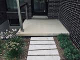 Irregular sandstone stepping stones keep your feet dry in the rain at this Ann Arbor Michigan contemporary home. 