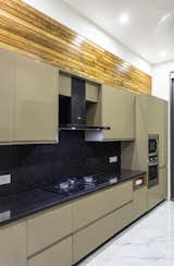 Black galaxy granite used in the kitchen counter and dado area gives the illusion of infinite surface.
