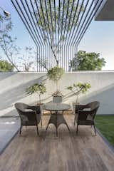 The rear wooden floor deck provides for an outdoor seating with a semi – sheltering louvered pergola above.
Another issue of monkeys invading the house had to be dealt with, which was resolved by providing spikes above the compound walls.