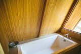 A bathroom in the A-frame features a large soaking tub.