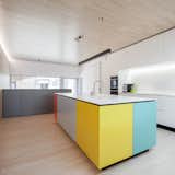 Kitchen, Cooktops, Light Hardwood Floor, Pendant Lighting, Refrigerator, Drop In Sink, Colorful Cabinet, White Cabinet, and Recessed Lighting  Photo 11 of 23 in Private House and Architecture Office by Daphné Römer