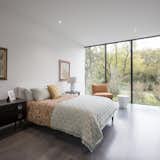 Within each bedroom, the architecture acts as a frame to the landscape beyond. The opening picture faces east towards the land and water conservation project across the street; it is 10' h x 15' w. The colors within each bedroom were selected to compliment the species of plants outside the home.