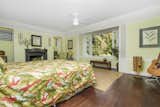 Master bedroom is classic Hawaiiana with original hardwood floors, original sliding windows, and fireplace 