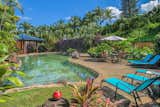 Outdoor, Flowers, Hardscapes, Trees, Shrubs, Grass, Boulders, Back Yard, Concrete Patio, Porch, Deck, Large Pools, Tubs, Shower, Salt Water Pools, Tubs, Shower, and Walkways Private lagoon swimming pool  Search “lagoon” from Mahina Kai