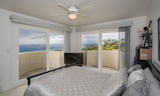 Guest bedroom with panoramic view from multiple balconies.