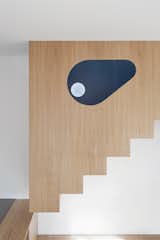 Staircase, Wood Railing, and Wood Tread The eye-shaped hole of the stairs volume  Photo 5 of 12 in Into the Woods by gosplan architects