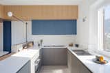 Kitchen, Drop In Sink, Wall Oven, Cooktops, Engineered Quartz Counter, Colorful Cabinet, Concrete Floor, and Wall Lighting View of the kitchen  Photo 7 of 12 in Into the Woods by gosplan architects
