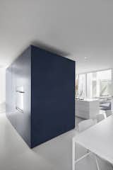 A dark blue block is the central pole of the kitchen area. Deposited directly on the floor, its periphery creates a zone of circulation.
