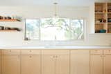 Kitchen, Laminate Counter, Light Hardwood Floor, Wood Cabinet, Pendant Lighting, and Undermount Sink Kitchen  Photo 10 of 16 in Midcentury Dream House by Madeline Tolle