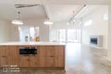 Kitchen, Engineered Quartz Counter, Pendant Lighting, Microwave, Concrete Floor, and Wood Cabinet  Photo 8 of 14 in Traxler 1 by BLOM Design Studio