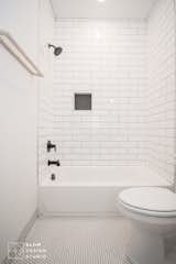Bath Room, Alcove Tub, Subway Tile Wall, Recessed Lighting, Porcelain Tile Floor, Open Shower, and One Piece Toilet  Photo 14 of 14 in Traxler 1 by BLOM Design Studio