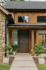 Mountain modern lake house located at Lake Keowee, SC. Natural exterior materials include thermotreated wood cladding and natural stone, blending the home into the nature leaving room for the beautiful mountain and lake views that surrounds this home.