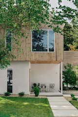 The material & color palette of this home is very minimal but inviting, limited to stucco and thermotreated wood cladding on the exterior and warm white paint colors, white oak, and aluminum windows and doors.