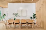 Scandinavian dining room with dining table from Muuto and dining chairs from HAY. The white oak wood slat wall works as a partition wall between the dining space and the staircase.