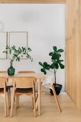 Scandinavian dining room with dining table from Muuto and dining chairs from HAY. The white oak wood slat wall works as a partition wall between the dining space and the staircase.