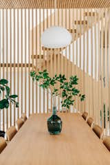 Scandinavian dining room with dining table from Muuto and dining chairs from HAY. The white oak wood slat wall works as a partition wall between the dining space and the staircase.