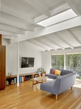 Custom walnut built-ins offer storage and reduce the need for furniture in the Tamalpais Street Residence. Ogawa Fisher Architects removed a large central room divider to create a bright, open space.