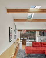 A built in bench provides storage and seating while visually connecting the living and dining areas. The composition and placement of windows and skylights balance the need for light and views. 