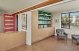 A new library tucked off the front entry houses the family’s book and toy collection, and opens to the expansive living room, dining room, and kitchen area. 