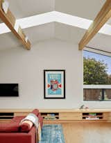Ridge skylights in a vaulted ceiling welcome light into the open living space of the family's home. 