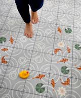 Whimsical, cement goldfish tiles decorate the floor of the kid's bathroom. 