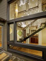 A two-story glass wall and stunning custom stair, crafted from a single piece of folded acid-etched metal. 