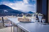 The kitchen countertop extends onto the deck to form a bar with a view of the Rockies. 
