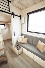 Storage Room This built-in custom couch offers ample storage underneath.

  Photo 5 of 14 in This Sleek Travel Trailer Is Practically a Cabin on Wheels from Land Ark RV - Drake