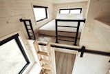 The loft ladder can be hung against the wall as shown or secured at an angle for ergonomic climbing. The master loft easily fits a king size bed. Ladder and built-ins designed by Land Ark, cut and assembled by Twig Custom Builders.