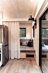 Living Room, Ceiling Lighting, Vinyl Floor, and Sofa A privacy curtain turns this area into its own room.   Photo 2 of 21 in Love It/Hate It: Room Divider Curtains by Dwell from Land Ark RV - Draper