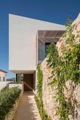 Exterior, Tile Roof Material, House Building Type, Stucco Siding Material, Stone Siding Material, Glass Siding Material, Wood Siding Material, and Shed RoofLine  Photo 14 of 14 in M24 House by OLARQ Osvaldo Luppi Architects